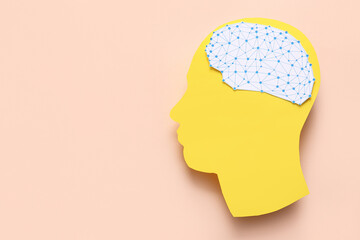 Paper human head with brain on pink background. World Mental Health Day