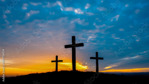Three religious crosses stand in silhouette against a dramatic sunset sky with vibrant colors and scattered clouds