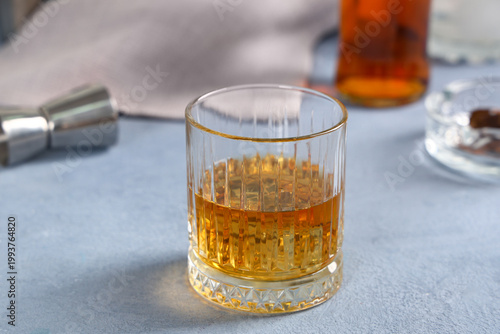 Glass of cold rum on table ...