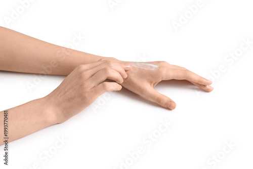 Quadro su tela Beautiful female hands applying cosmetic cream on white background