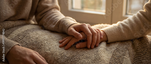 support comfort care holding hands empathy warmth cozy home connection sunlit handholding over a blanket shows trust and emotional closeness for recovery wellness and comforting home themes