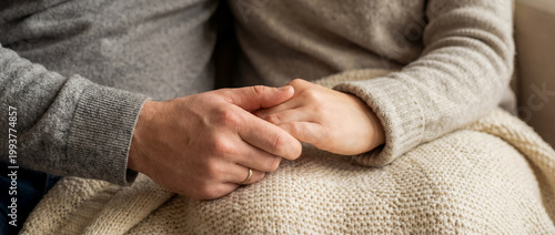 support comfort care holding hands empathy warmth cozy home connection hands resting together over a knitted blanket show healing and calm connection for therapy wellness and support themes