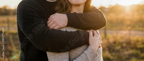 support comfort embrace warmth tenderness outdoor sunset trust connection care outdoor embrace in sunset light shows affection trust and calm support for wellness and relationship themes