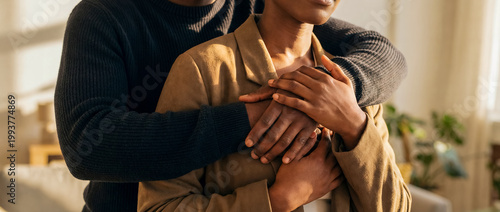 black couple support comfort embrace warmth trust connection home care caring embrace in warm indoor light shows emotional safety trust and togetherness for inclusive relationship wellness themes