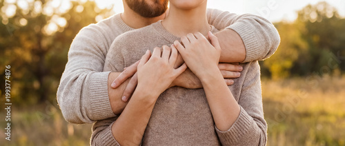 support comfort embrace warmth tenderness outdoor sunset trust connection care a warm back hug in evening light shows affection trust and emotional safety for relationship wellness and support themes