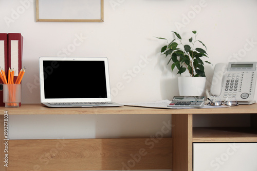Blank laptop with plant and...