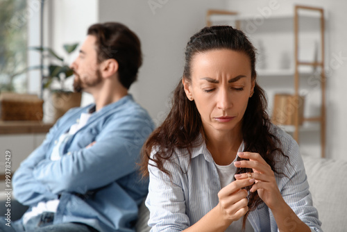 Unhappy woman taking off he...