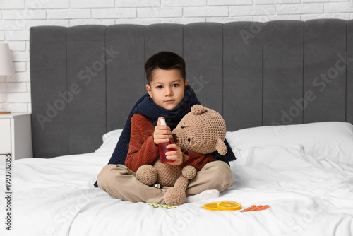 Ill little Asian boy with s...
