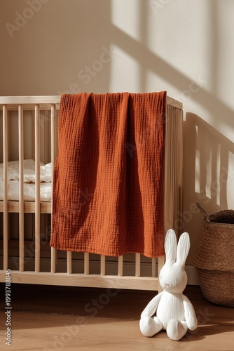 Minimalist Nursery Interior with Wooden Crib and Orange Blanket