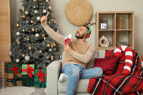 Young man taking selfie wit...