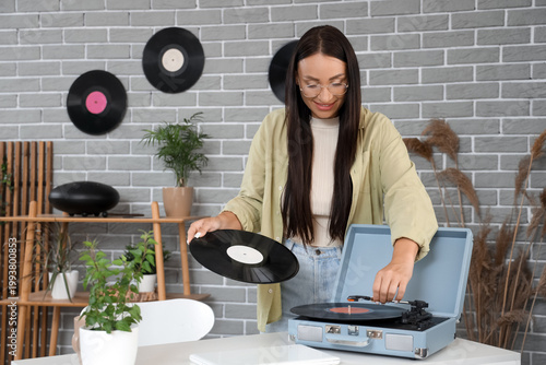 Young woman with vinyl disk...