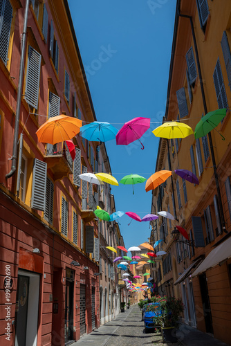 Colorful umbrellas in the city .City street in Modena, Italy with rainbow colored umbrellas overhead, vibrant urban scene, summer atmosphere, travel destination