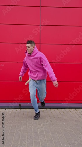Hip hop dancer practicing dance routine performing freestyle moves in city. Modern dance choreography. Urban dancer showing skills. Vertical video. 4K, UHD