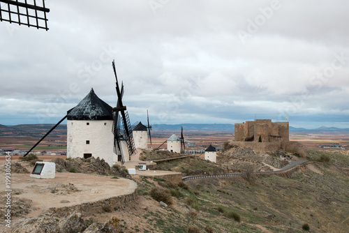 Traditional windmills in a row and ancient castle in Consuegra, Toledo, Spain
