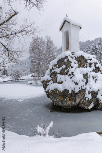 White chapel on snow covered rock Liptovsky Hradok Slovakia