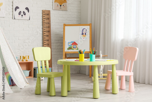 Photos Table with chairs and blackboard in children's room