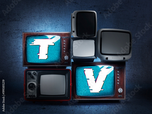 Old TV sets on dark background. Letters T and V on displays