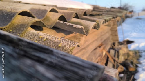 Snow melts on the roof, drops of water fall to the ground. Spring thaw. Spring mood.