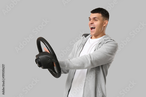Young man with steering whe...