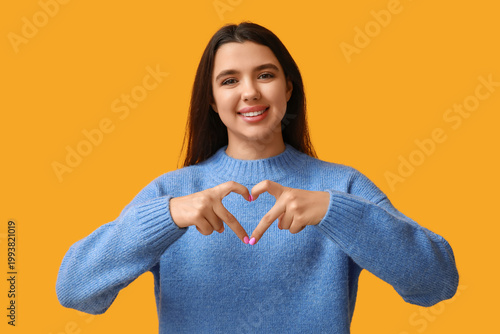 Happy young girl showing he...