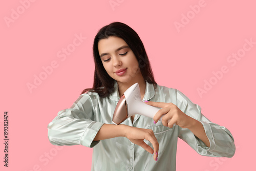 Beautiful young woman using...
