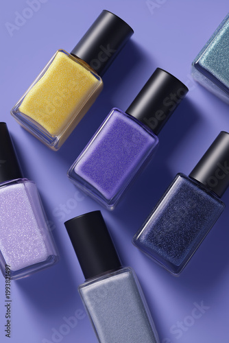 Assortment of shimmering nail polish bottles in various shades of purple and blue