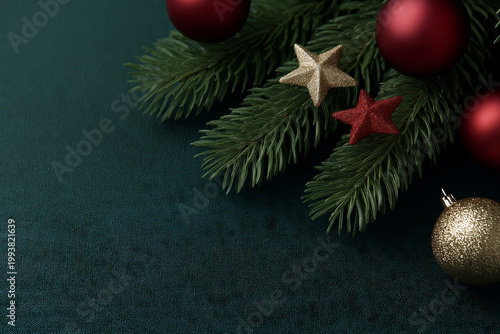 Festive Christmas fir branch with red and gold ornaments and stars on dark background