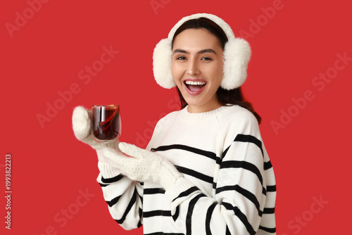Happy young woman in warm m...