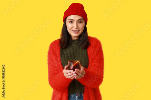 Young woman with glass cup ...