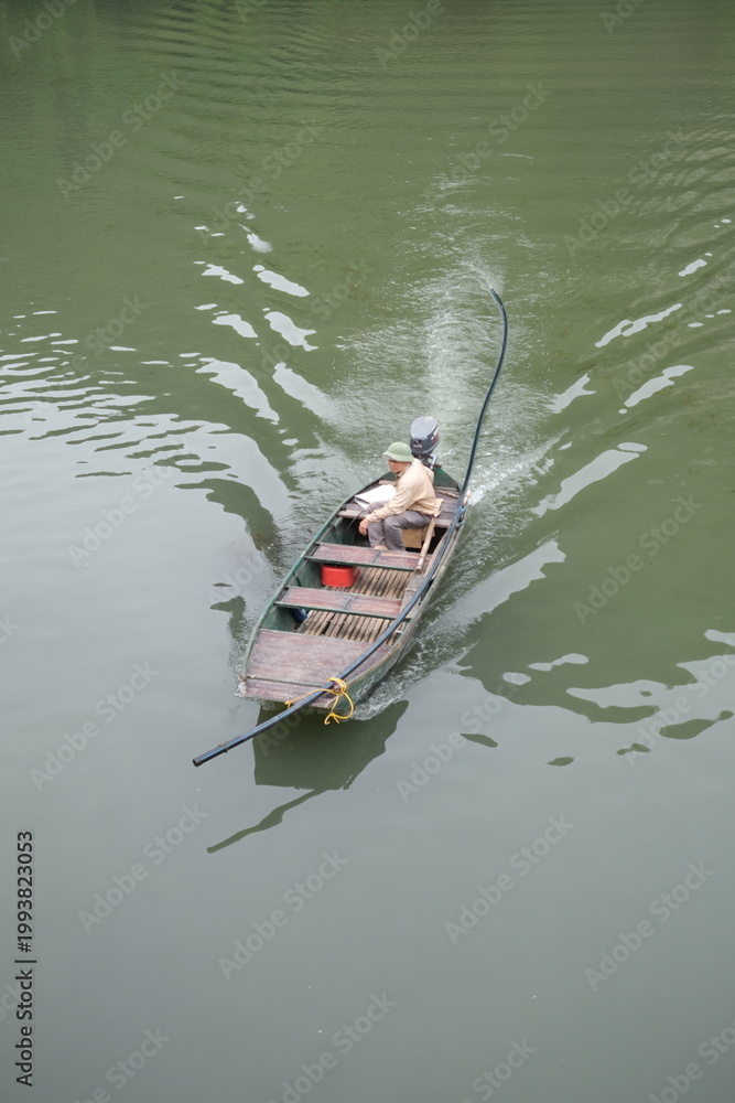 Fototapeta premium Fisherman in boat, Vietnam Editorial use only