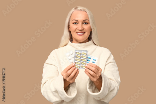 Mature woman with pills on ...