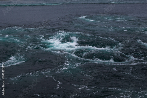 Fotografie Powerful churning whirlpool in Saltstraumen, Norway