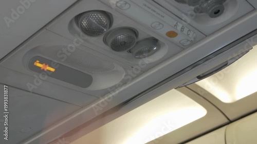Hand switch off personal light above seat on airplane, Comfort flight light for reading,turn off button on console panel onboard for passenger.