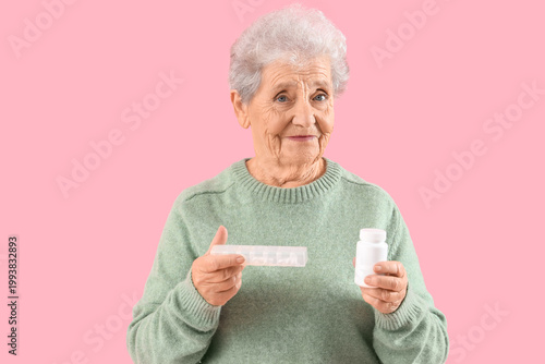 Senior woman with pills on ...