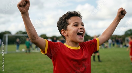A young boy football player celebrating a goal. Concept of active childhood and love for the sport.