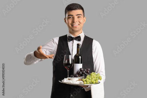 Young sommelier with wine a...