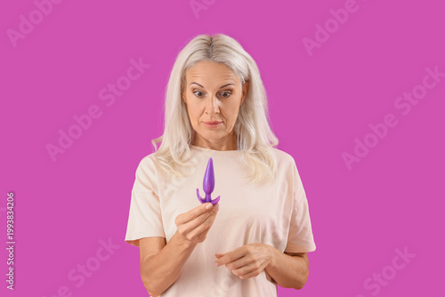 Canvastavla Shocked mature woman with anal plug on purple background