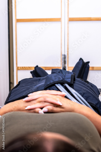 Person receiving lymphatic drainage pressotherapy treatment for body wellness and recovery