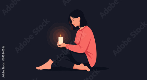 Woman holding a candle while sitting on the floor in a dark room during evening hours