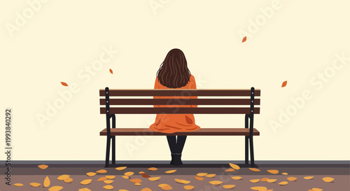 Woman sits on a bench under falling leaves in a quiet place during autumn afternoon