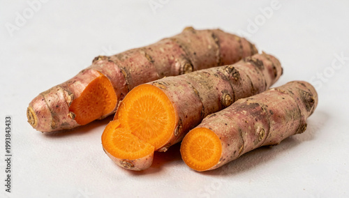 Ginger root showing sliced ends revealing orange inner layers