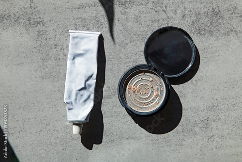 Empty Cosmetic Tube and Case on Gray Surface