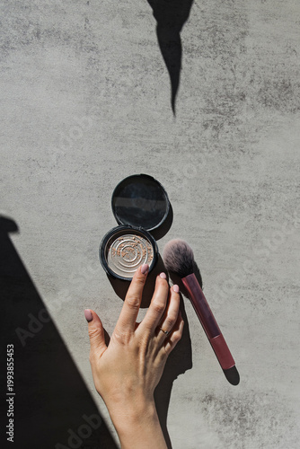 Hand with Makeup Brush and Compact Powder