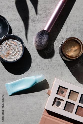 Makeup and Skincare Essentials on Gray Surface