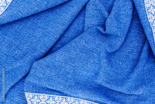 Fotografija Soft blue fabric with white pattern lays flat on a surface showing texture