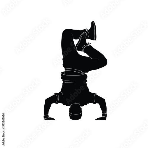 Breakdancer executes a complex upside down move on the floor.