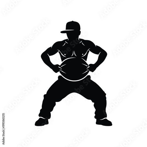 Dancer in a cap performs an urban athletic move in a dynamic silhouette.