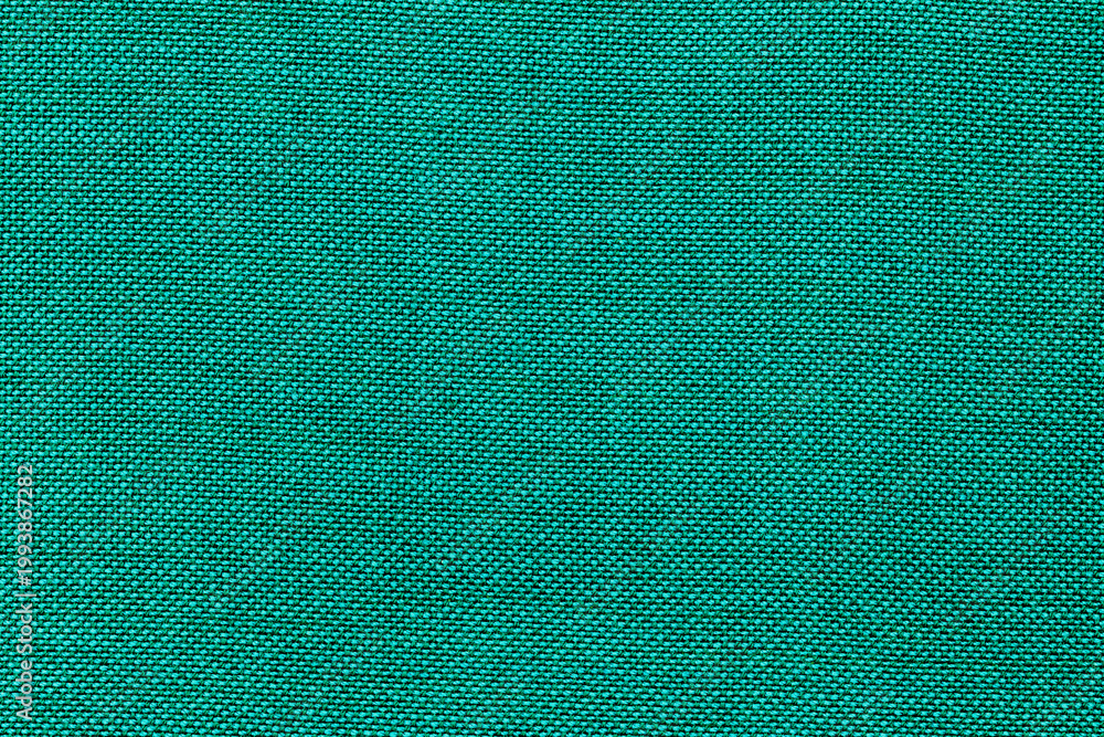 Fototapeta premium Fabric with a solid teal color used in various textile projects during the day