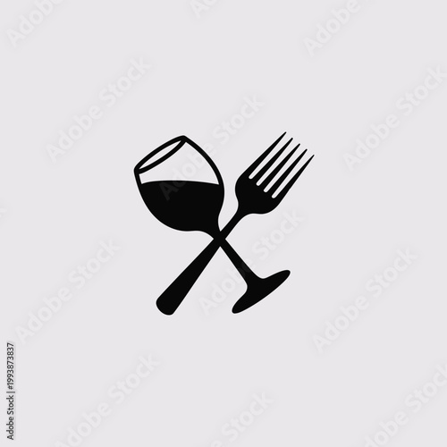 Wine glass and a dinner fork crossed create a symbolic representation of fine dining experiences.