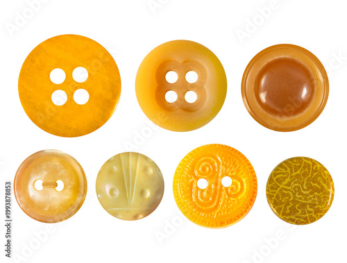 Isolated photo of orange and yellow colored cloth buttons on white backdrop.